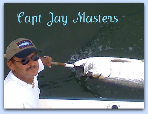 CAPT JAY MASTERS WITH A TARPON RELEASE.